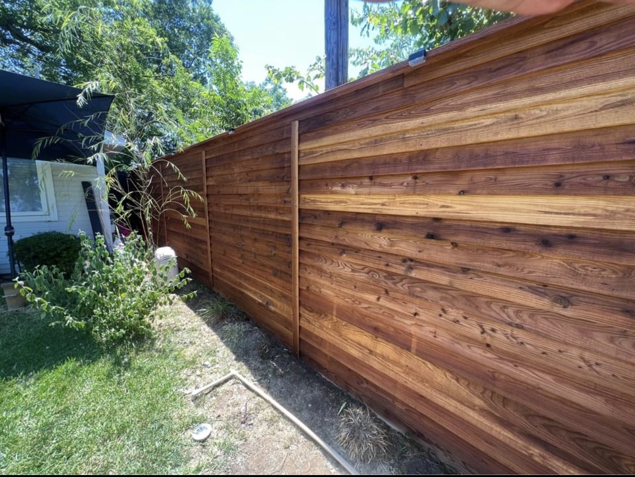 A completed horizontal cedar fence by The Fence Pros