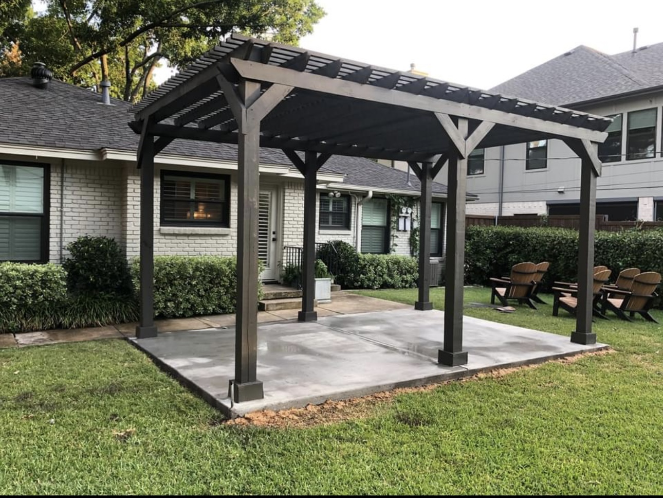 A wood pergola over a backyard patio